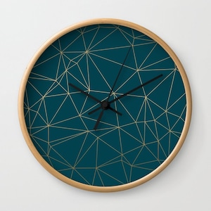 May include: A teal blue clock with a gold geometric pattern and black hands.