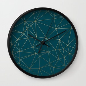 May include: A teal blue wall clock with a black frame and gold geometric pattern.