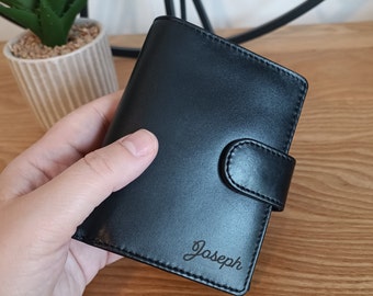 May include: Black leather wallet with a flap closure and the name "Joseph" engraved on the front.