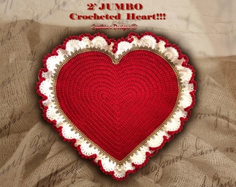 May include: A large, red crocheted heart with a white and gold crocheted border. The heart is 2' in diameter and is sitting on a burlap background. The text "2' JUMBO Crocheted Heart!!" is written above the heart.