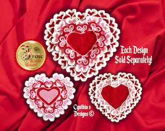 May include: Three crocheted heart-shaped doilies in red, pink, and white. The doilies are layered with smaller hearts and have a scalloped edge. The text "Each Design Sold Separately!" is visible in the image.