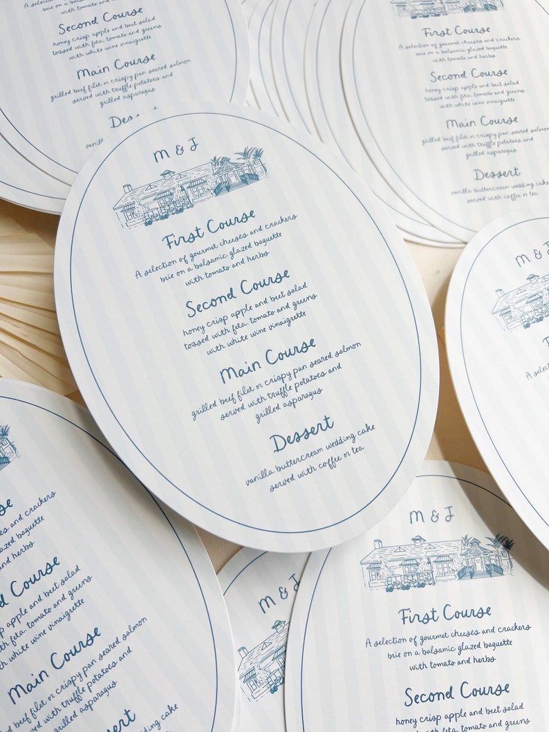 May include: A set of round, white paper place cards with blue text and a blue illustration of a house. The text on the cards reads "M&J" and lists a wedding menu with the courses: First Course, Second Course, Main Course, and Dessert.