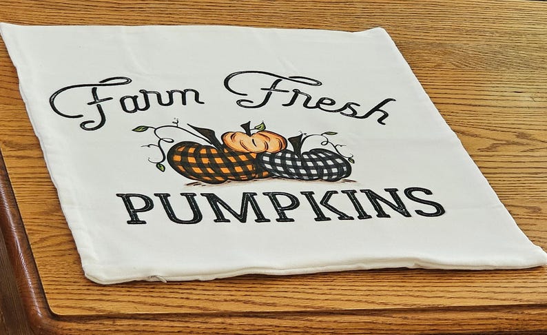 18x18 inch canvas pillow cover hidden zipper reads farm fresh pumpkins with 3 pumpkins on it two of them are buffalo plaid image is permanently embedded into the fibers of the fabric and will never come off machine wash tumble dry pillow cover only
