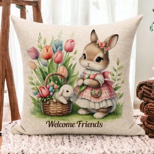 May include: A decorative pillow with a linen texture features a cartoon bunny holding a bouquet of colorful tulips. The bunny is wearing a pink and white dress with a floral pattern. The pillow has the text "Welcome Friends" printed on it.