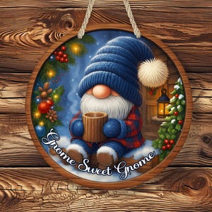 May include: A round wooden sign featuring a gnome in a blue knit cap and plaid outfit, holding a mug. The sign has the text "Gnome Sweet Gnome" and is decorated with winter elements like a Christmas tree and berries.