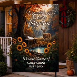 May include: A rectangular garden flag featuring a forest scene with a deer, a squirrel on a tree, a wooden bench, a pond, and sunflowers. Text reads: A beautiful soul is never forgotten. In Loving Memory of Doug Smith 1958 - 20XX.