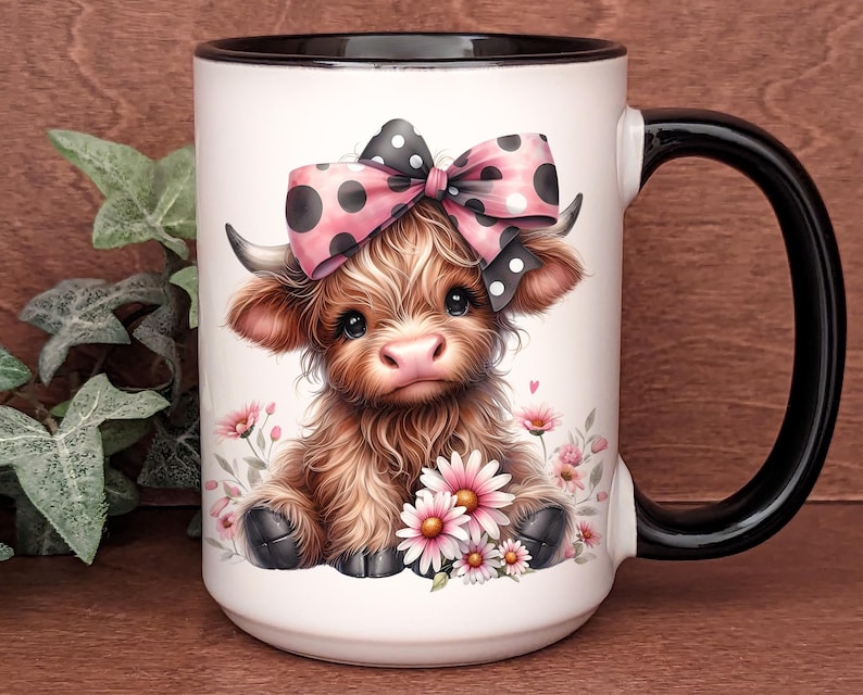 A beautifully designed personalized Highland Cow mug featuring an adorable brown cow with a pink and black polka dot bow, surrounded by soft pink flowers. This 15-ounce ceramic mug is available with a black, white, or blue handle.