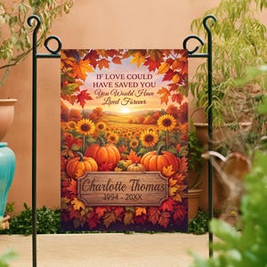 May include: A rectangular garden flag featuring a vibrant autumn landscape with orange pumpkins, yellow sunflowers, and red maple leaves. The text reads: IF LOVE COULD HAVE SAVED YOU You Would Have Lived Forever, with a wooden plaque displaying Charlotte Thomas 1994 - 20XX.