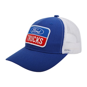 May include: A blue trucker hat with a white mesh back and a curved brim. The hat features a patch with the Ford logo and the word "TRUCKS" in white letters on a red background.