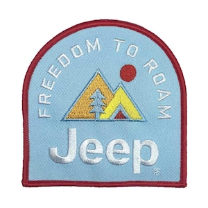 May include: Embroidered patch with a light blue background and a red border. The patch features a mountain scene with a yellow tent, a tree, and a red sun. The words "FREEDOM TO ROAM" and "Jeep" are embroidered in white.