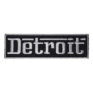 Op de afbeelding: Zwart-witte geborduurde patch met het woord "Detroit" in witte letters.