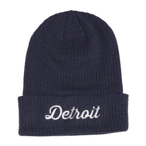 May include: A navy blue knit beanie with a white embroidered "Detroit" logo.