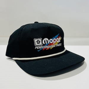 Könnte beinhalten: Schwarze Baseballkappe mit flachem Schirm und weißem Seildetail. Die Kappe hat den gestickten Text "Mopar PERFORMANCE PARTS" in Weiß, Rot, Gelb und Blau. Ein weißer Stern befindet sich in einem Quadrat links vom Text.