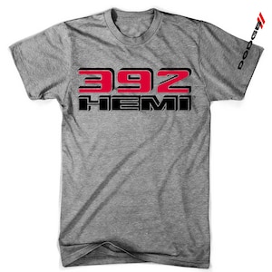 May include: Grey t-shirt featuring the text "392 HEMI" in red and black. The word "Dodge" is printed vertically on the right sleeve.