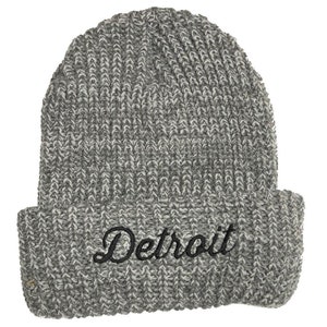 May include: Gray knitted beanie with a black embroidered "Detroit" logo.