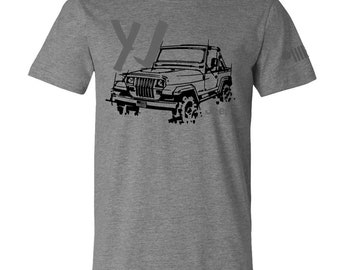 May include: Gray t-shirt featuring a black line drawing of a Jeep YJ. The design includes the letters "YJ" in a faded gray color. The Jeep is depicted with its top down, and the word "Jeep" is partially visible.