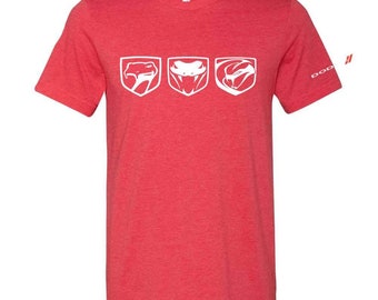 May include: Red t-shirt featuring three white snake head logos, each with a unique design. The logos are positioned horizontally across the chest. The shirt has a crew neck and short sleeves. The text "DOD" is printed on the right sleeve.