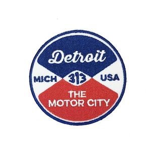 May include: A blue, red, and white circular patch with the text "Detroit, Mich 313 USA, The Motor City".