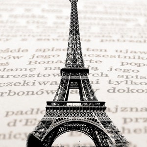 May include: A black and white illustration of the Eiffel Tower, a famous landmark in Paris, France. The tower is depicted against a blurred background of text.