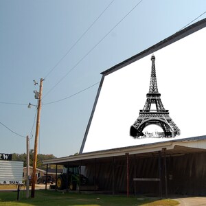 May include: A drive-in movie theater with a large billboard displaying a black and white image of the Eiffel Tower. The billboard reads "MT. VIEW CLOSED OPEN FRI, SAT, & SUN."
