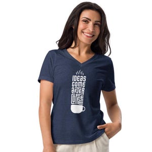 May include: Navy blue V-neck t-shirt with the white text "IDEAS COME AFTER COFFEE" in a vertical design. The design includes a coffee cup and steam graphics. The shirt is made of a soft, comfortable material.