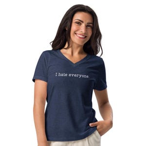 May include: A navy blue V-neck t-shirt with the text "I hate everyone." The shirt is made of a soft material.