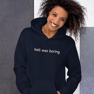 May include: A navy blue hoodie with a white print that says "hell was boring".