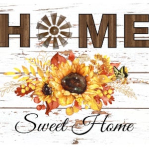 May include: A whitewashed wooden sign with the word "HOME" in brown letters, a vintage windmill design, and a floral arrangement of sunflowers, leaves, and a butterfly. The text "Sweet Home" is written in black cursive below the floral arrangement.