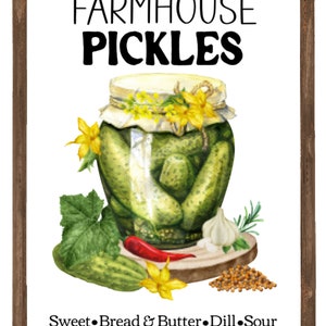 May include: A framed watercolor illustration of a jar of pickles with a white background. The jar is decorated with yellow flowers and a white cloth. The text "FARMHOUSE PICKLES" is at the top of the image. The text "Sweet Bread & Butter Dill Sour" is at the bottom of the image.