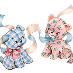 May include: Two plush toy figures: a blue plaid puppy with a pink bow and a pink floral cat with a blue bow. Both have stitched details and are adorned with flowing ribbons in pastel colors.