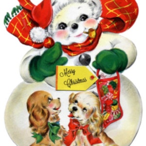 May include: A snowman wearing a red and black checked scarf and hat holds a yellow tag that says "Merry Christmas". Two brown and white dogs sit in front of the snowman. The snowman is wearing green mittens.