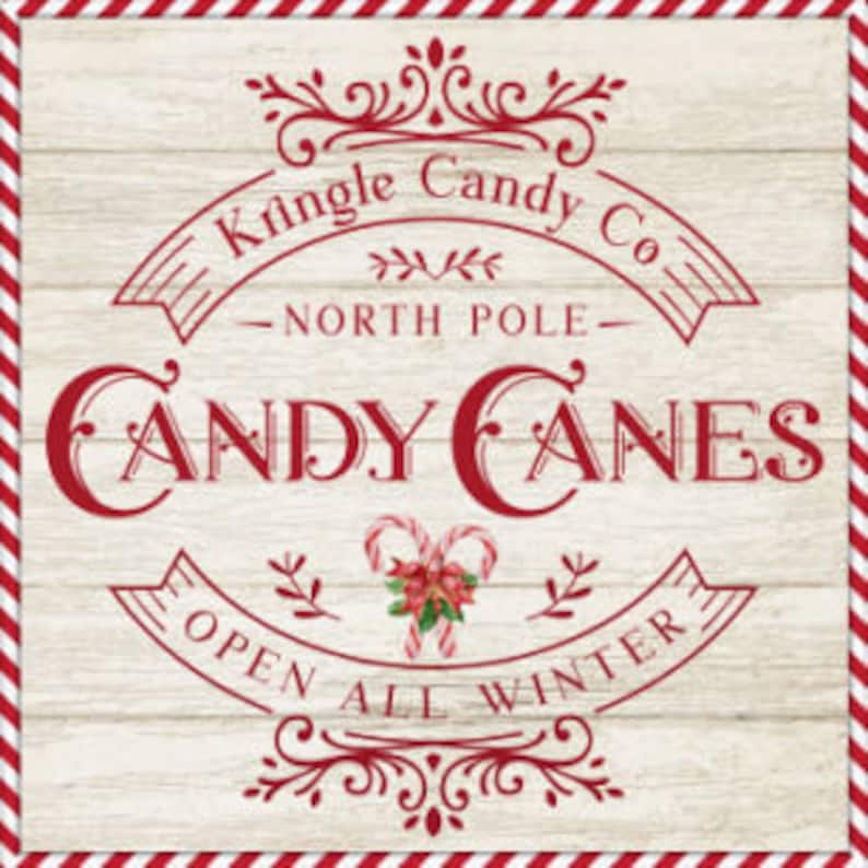 May include: A vintage-style sign for Kringle Candy Co. in North Pole, advertising candy canes. The sign is red and white with a woodgrain background and features a festive illustration of candy canes and a poinsettia.