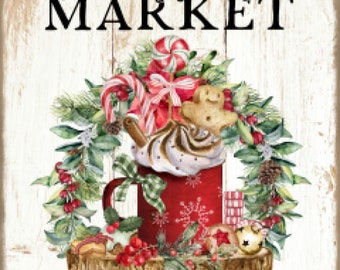 May include: A Christmas market sign with a red mug filled with whipped cream, candy canes, and a gingerbread man. The mug is surrounded by a wreath of greenery and red berries. The sign reads "Christmas Market" and "cookies, hot cocoa, candy canes, wreaths, ornaments".
