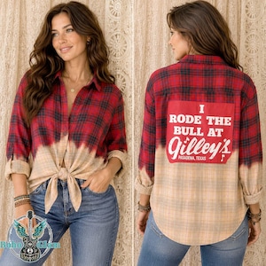 May include: A long-sleeve button-down shirt featuring a red and black plaid pattern that fades into a light tan at the bottom. The back displays a red rectangular patch with the white text I RODE THE BULL AT Gilley's PASADENA, TEXAS.