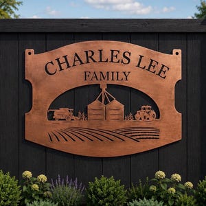 May include: A copper-colored metal sign with a curved top and bottom, featuring the text "CHARLES LEE FAMILY" in black lettering. The design includes a cutout illustration of a farm scene with two grain silos, a combine harvester, and a tractor.