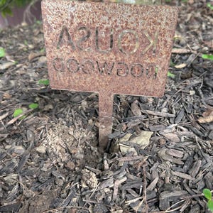 Plant marker in raw metal rusted backside of sign