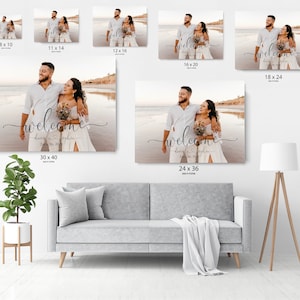 May include: A wedding welcome sign with a photo of a couple on a beach. The sign is printed on canvas and has the text "welcome" in a cursive font. The couple's names and wedding date are also included. The sign is available in various sizes, including 8x10 inches, 11x14 inches, 12x16 inches, 16x20 inches, 18x24 inches, 24x36 inches, and 30x40 inches.