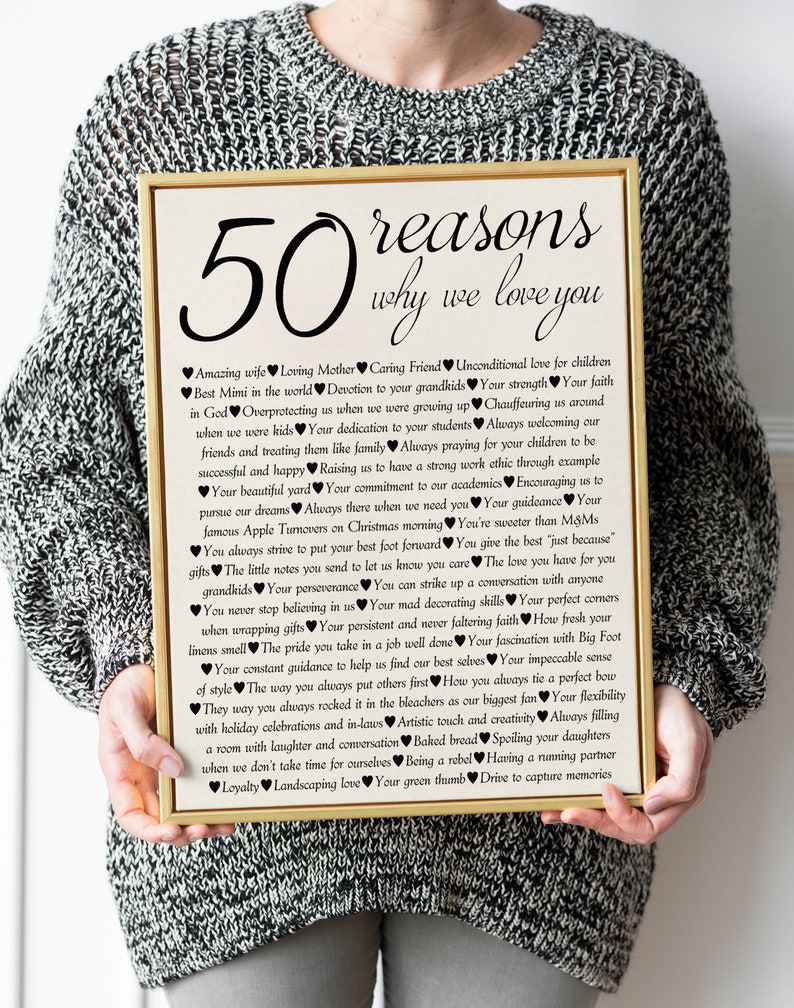 May include: A framed print with a gold frame and a white background. The print features a black and white design with the text "50 reasons why we love you" and a list of reasons written in black.