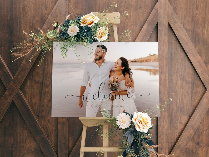 May include: A wedding welcome sign with a photo of a couple on a beach. The sign says "welcome daniela & sophia june 24, 2021".