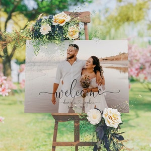 May include: A wedding welcome sign with a photo of a couple on a beach. The sign says "Welcome" with the couple's names, "Daniela & Sophia", and the date "June 26, 2021".