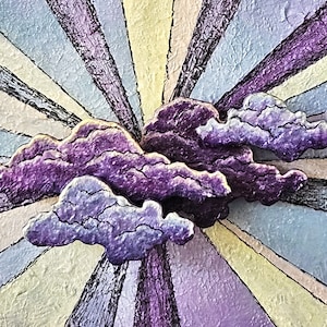 May include: A textured artwork featuring a stylized sunburst design with radiating stripes in shades of blue, yellow, and purple. Overlaid are three-dimensional, textured purple clouds with dark outlines, creating a whimsical, artistic composition.
