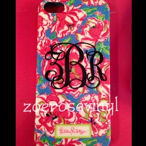 May include: A phone case with a floral pattern in pink, white, and green on a blue background. The case features a black monogram of the letters B, R, and a stylized font. The brand name "Lilly Pulitzer" is also visible.