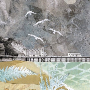 May include: An artistic illustration of a seaside scene. White seagulls fly across a textured, cloudy sky above a pier and buildings. The foreground features sand, shells, and foliage in muted tones.