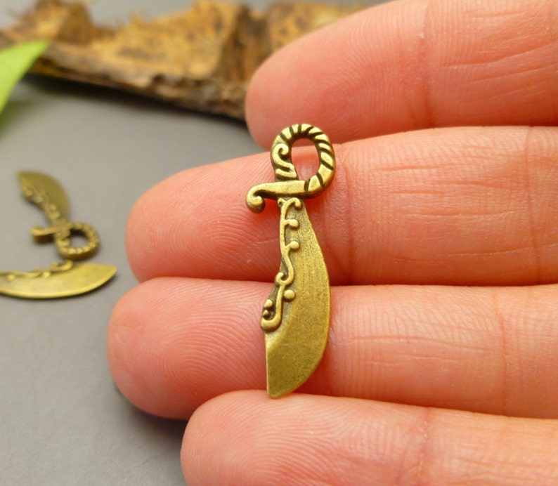 20 Antique Bronze Tone Sword charms Pirates Theme Charms Etsy