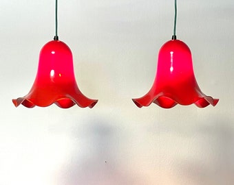 Paar moderne vintage Deense design plafondlampen uit het midden van de eeuw met oranje plastic kappen en blootstelling aan koel licht