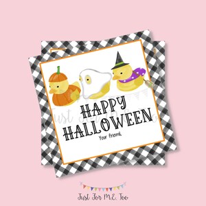 May include: A white card with black and white checkered border. Three yellow rubber ducks are dressed up for Halloween. One duck is a pumpkin, one is a ghost, and one is a witch. The card says "Happy Halloween" and "Your friend."