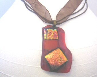 Fused Glass Pendant, orange dichroic on red glass, on 18 inch brown cord/ribbon