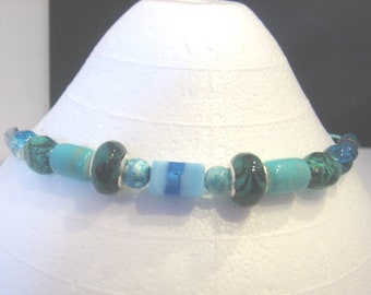 Teal glass bead choker on teal aluminum wire.