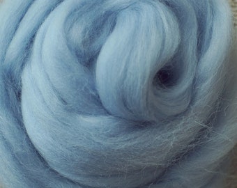 May include: A close-up of light blue wool roving, a type of fibre used for felting and spinning.
