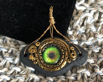 Evil eye Talisman necklace, green eye with gold accents, bronze bale, adjustable leather cord